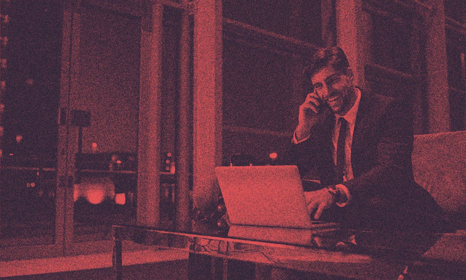 A man in suit talking on the phone.