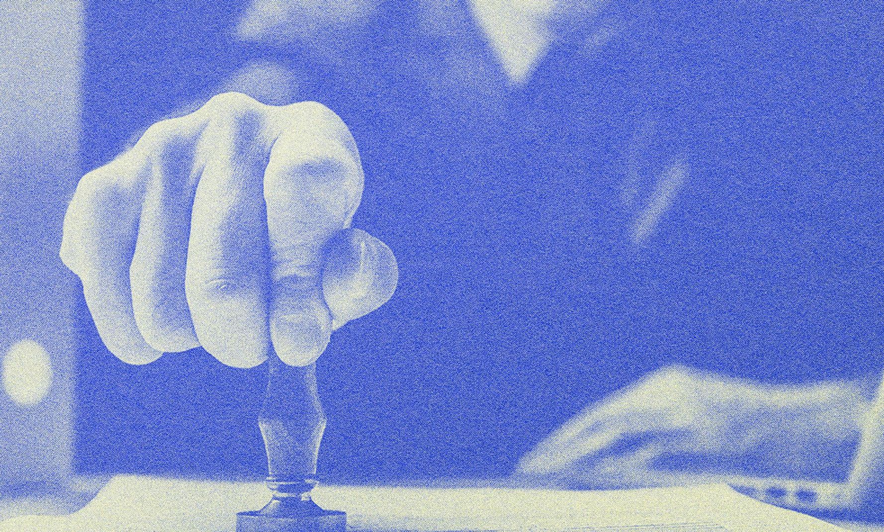 A man stamping on a piece of paper.