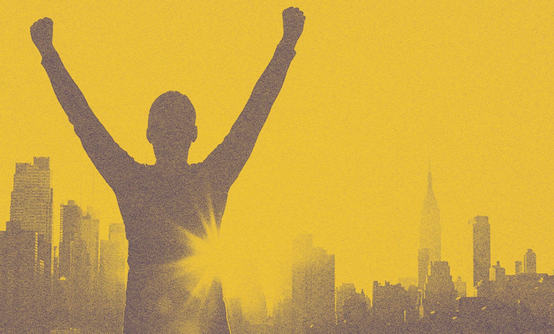 A person looking at the NYC with his arms up.