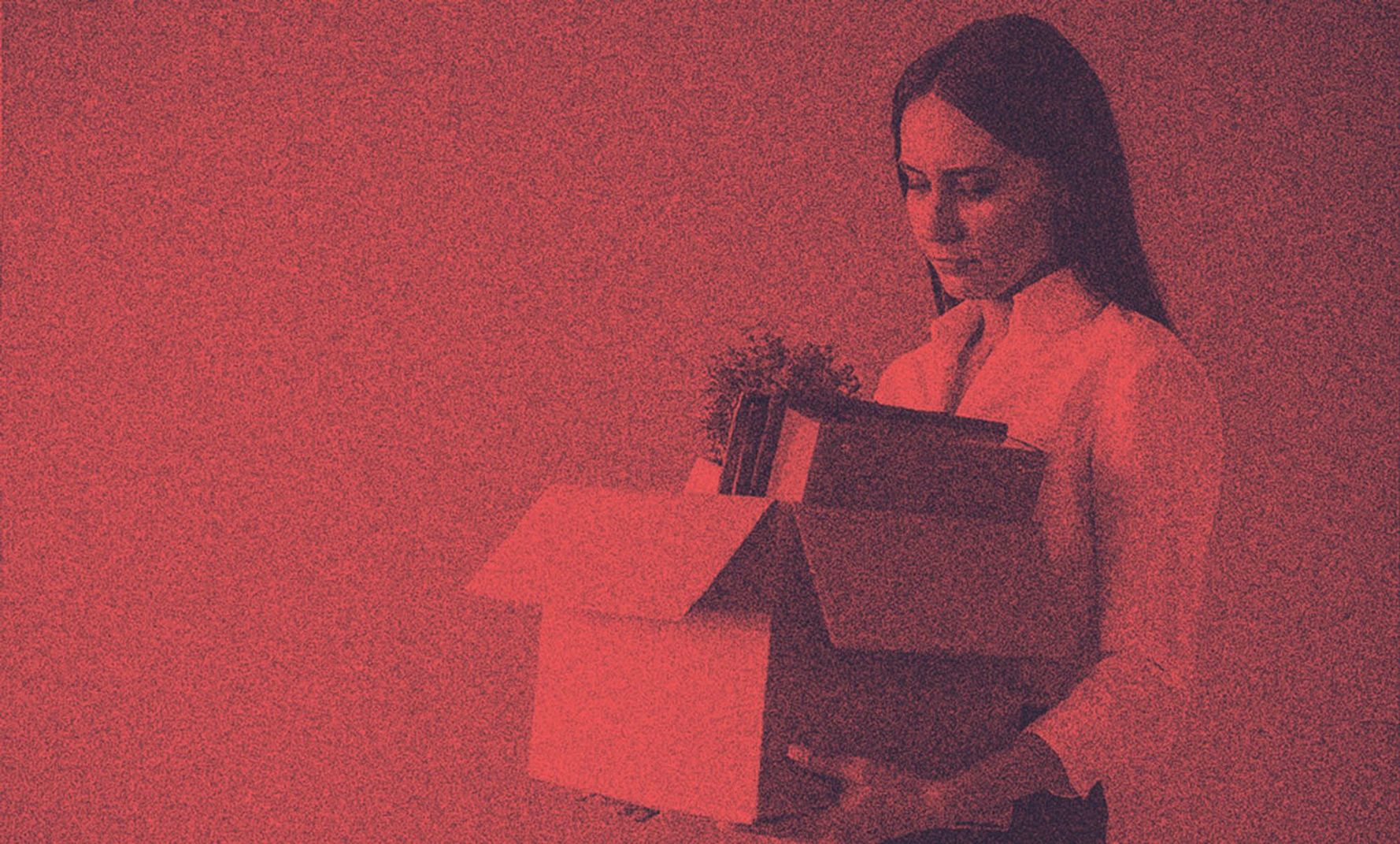 A woman with her stuff leaving work, probably furloughed.