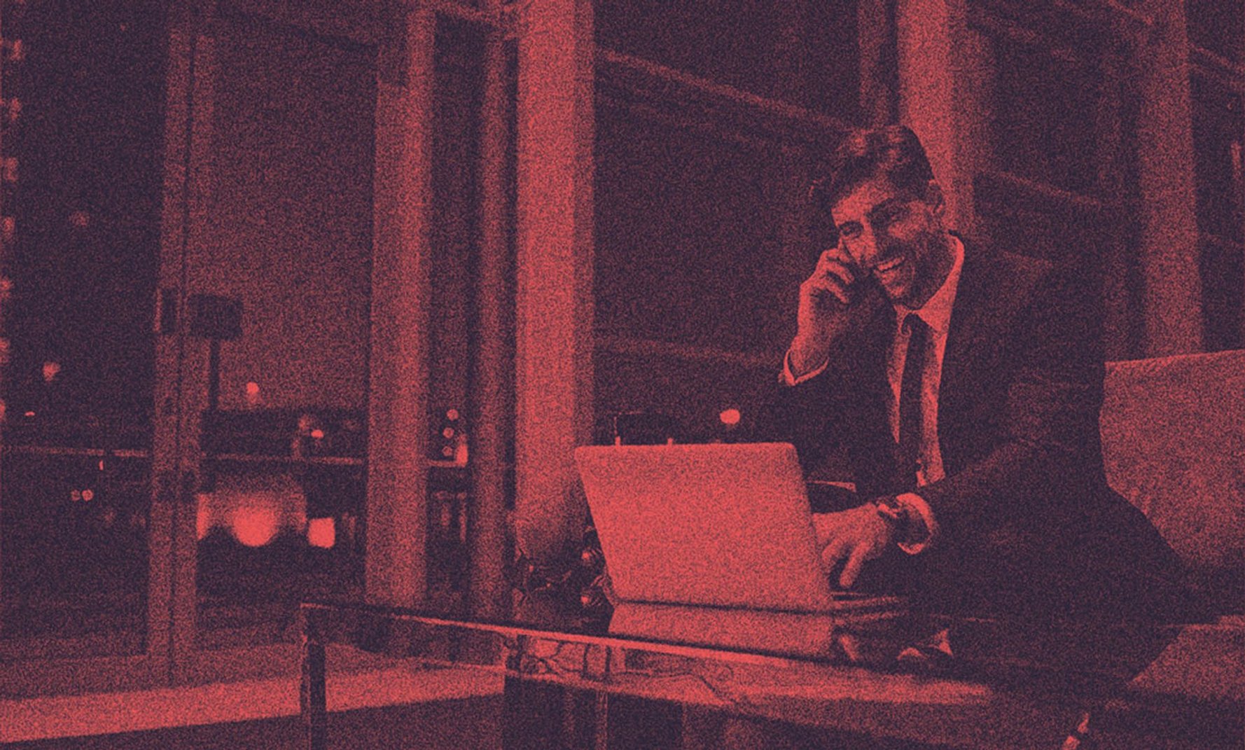 A man in suit talking on the phone.