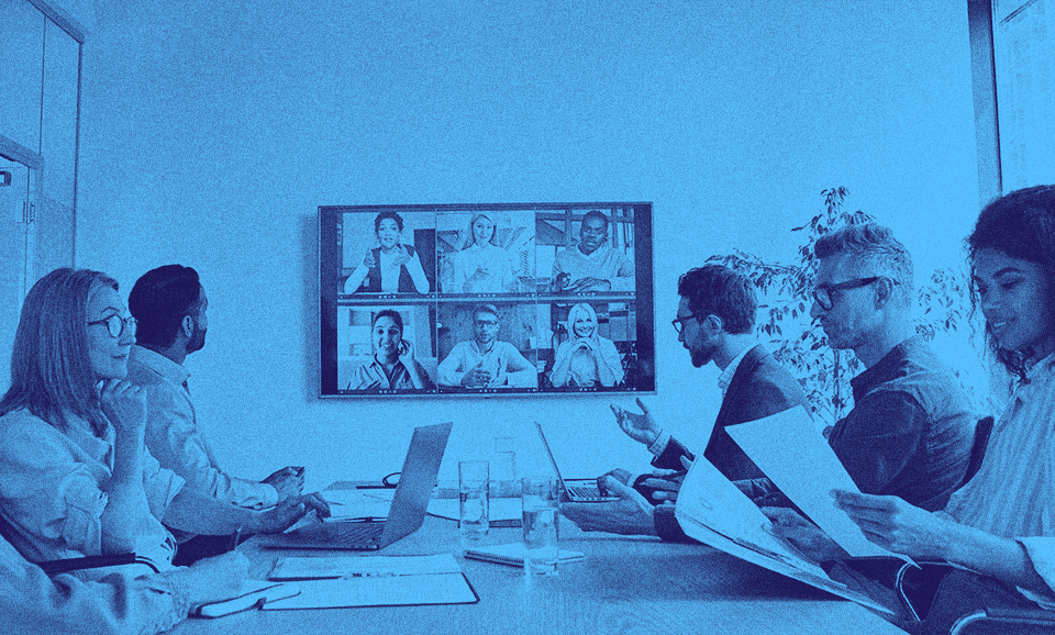 A group of people with the UK scale-up visa working in an office space.