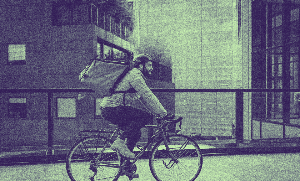 A person with a PERM Green Card riding a bike outside.