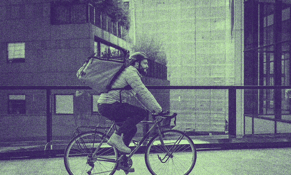 A person with a PERM Green Card riding a bike outside.