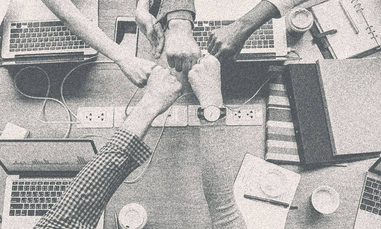 Several people fisting together.