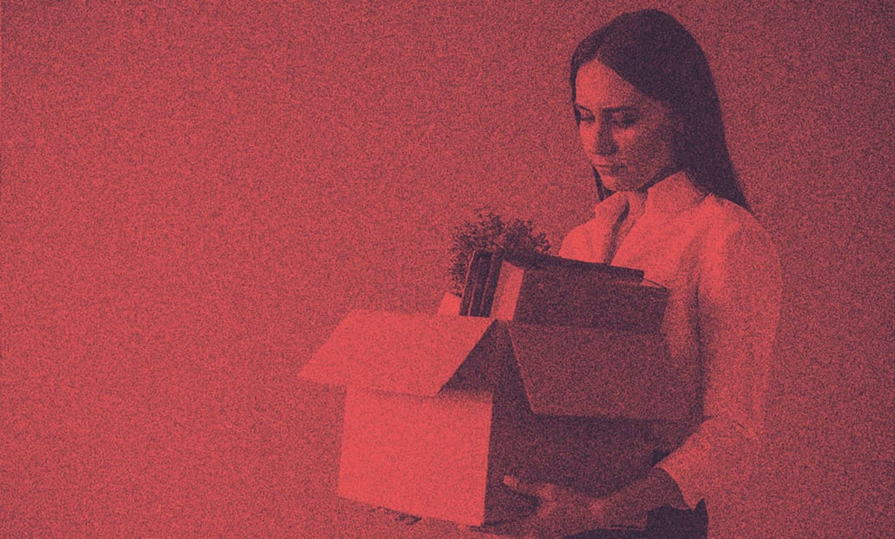 A woman with her stuff leaving work, probably furloughed.