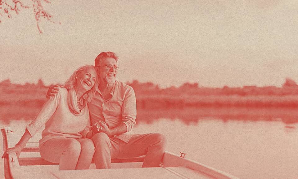 An old couple sailing on a kayak