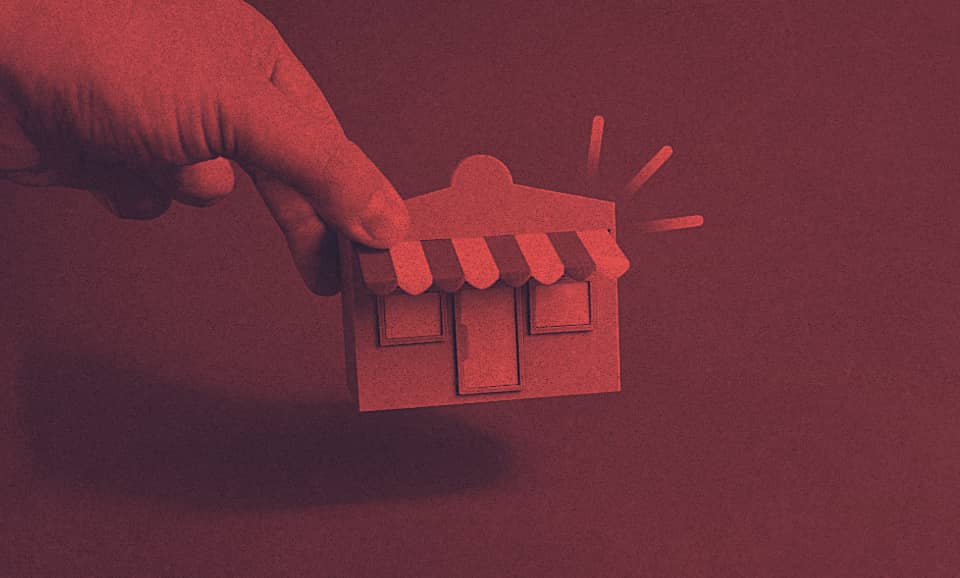 A person holds a model of a home.