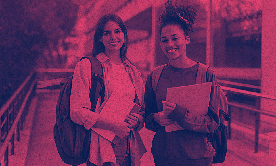 Two students smiling with their backpacks on