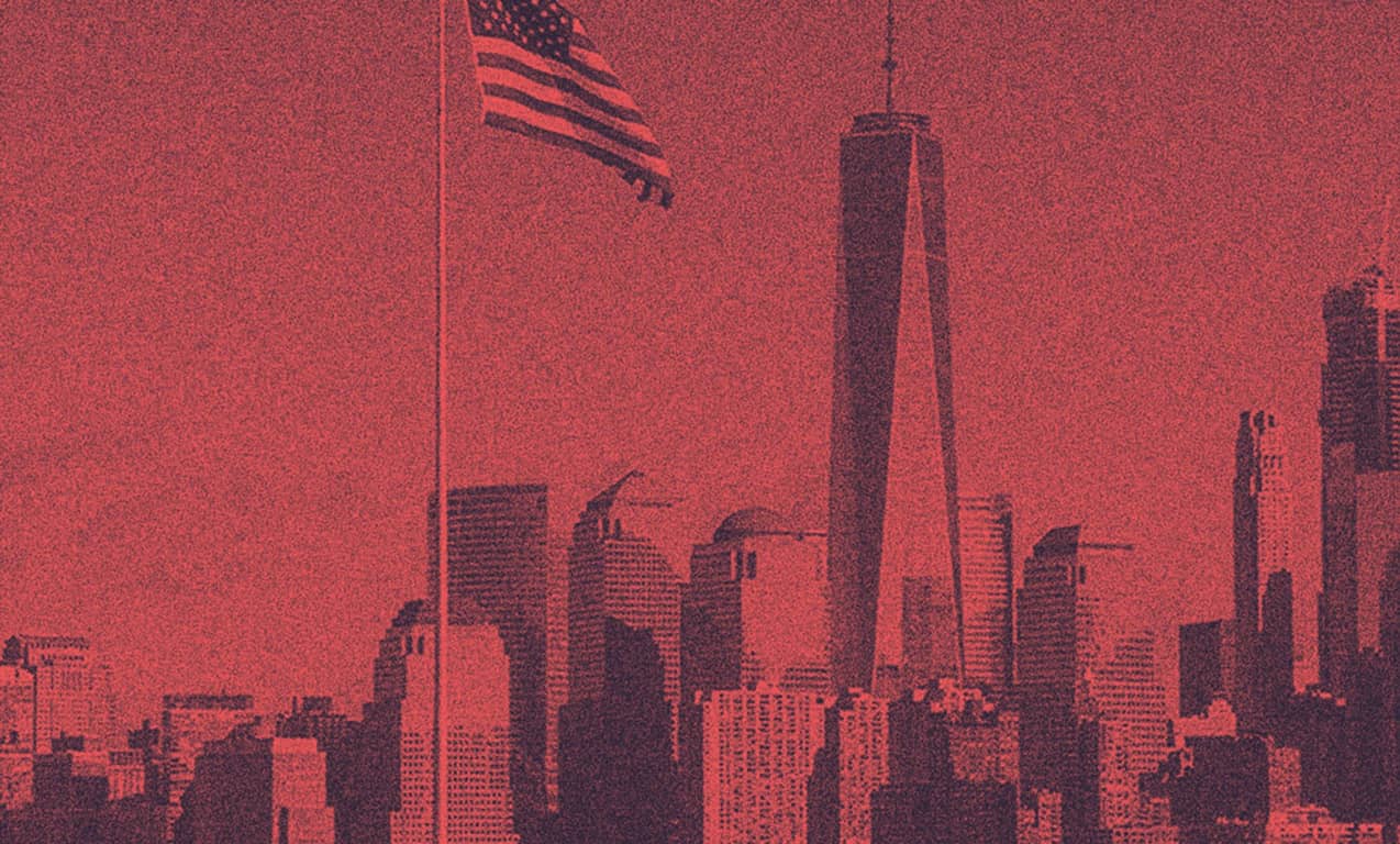 A view of the NYC with the USA flag hanging from above.