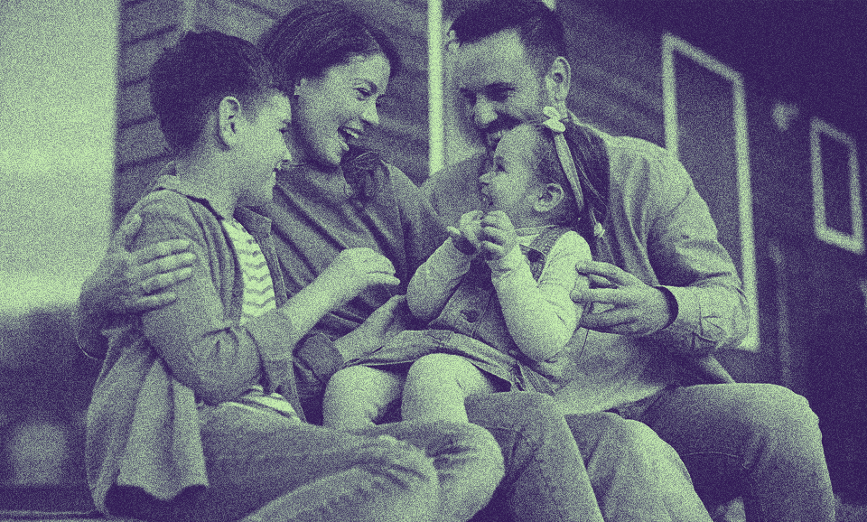 A family with two kids is outside together.