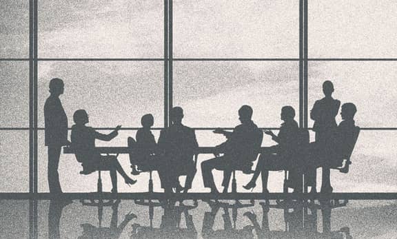 People in a meeting, only their silhouettes showing.