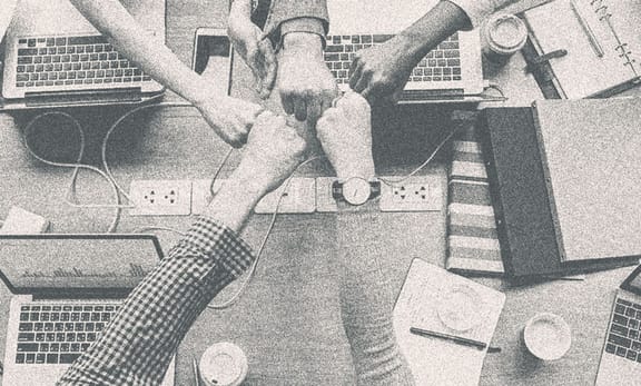 Several people fisting together.