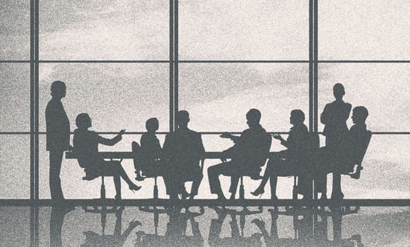 People in a meeting, only their silhouettes showing.
