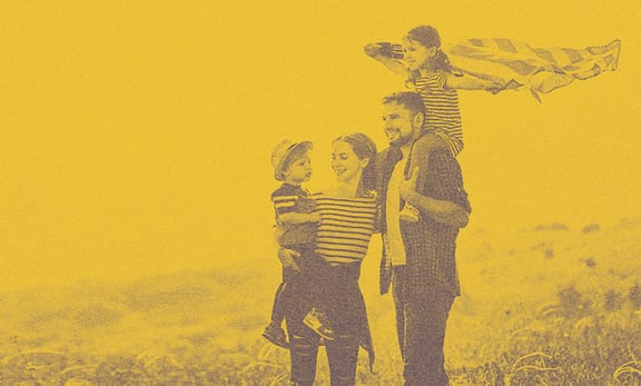 A family out on the fields, smiling.