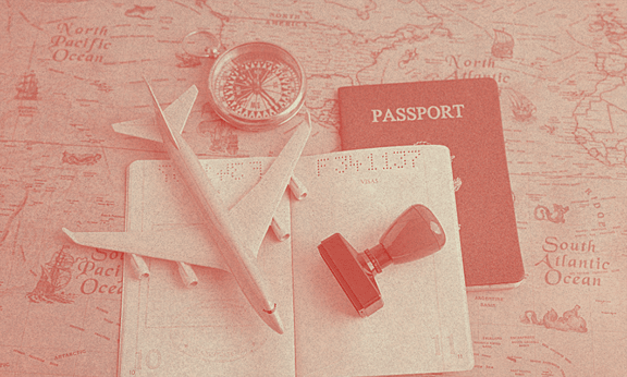 Açık bir Amerika pasaportu bir masanın üzerinde, maket bir uçakla birlikte.