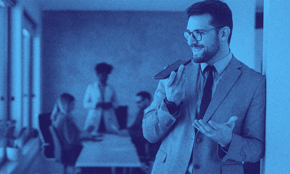 A man in suit with the UK innovator founder visa talking on his phone.