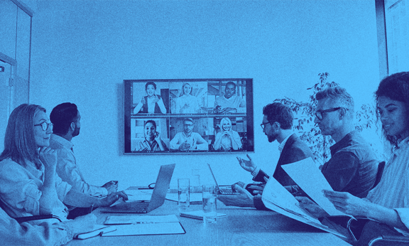 A group of people with the UK scale-up visa working in an office space.