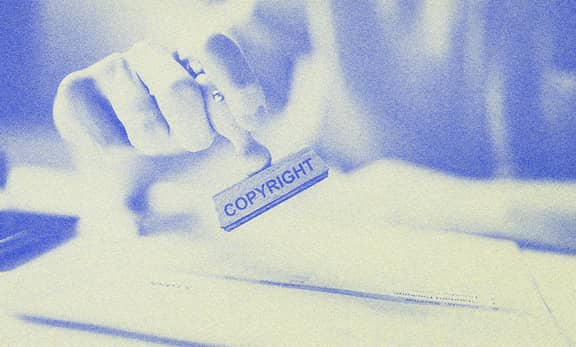 A person holding a stamp.