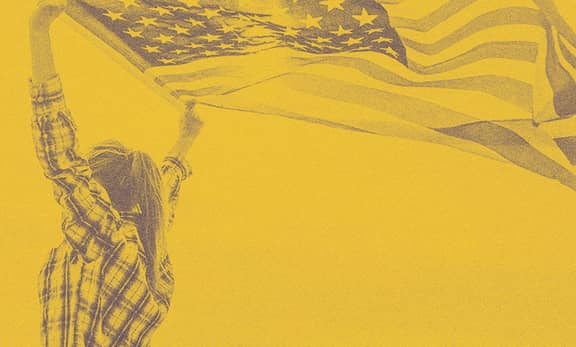 A woman lifting up the U.S. flag.