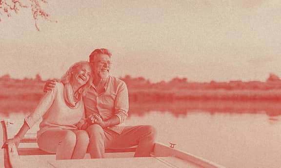 An old couple sailing on a kayak