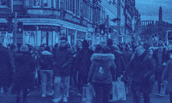 A crowd outside on a UK street.