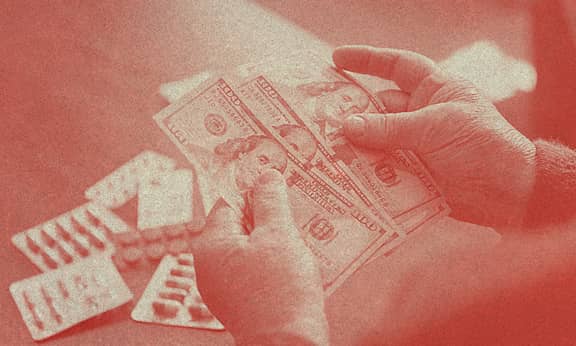 Bir insan elindeki dolar banknotlarını sayıyor.
