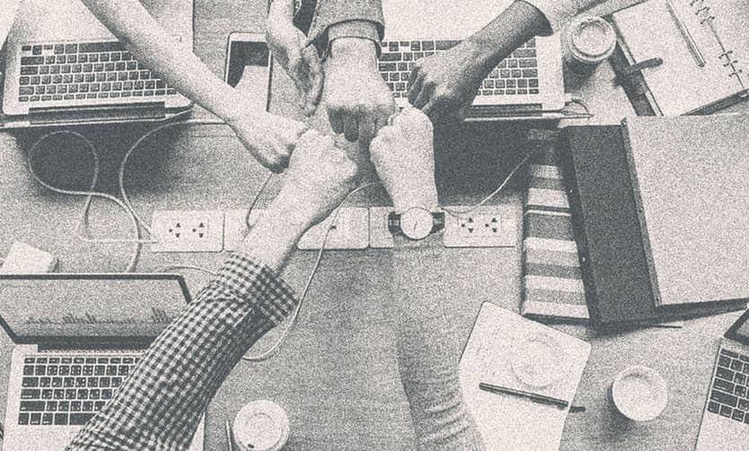 Several people fisting together.