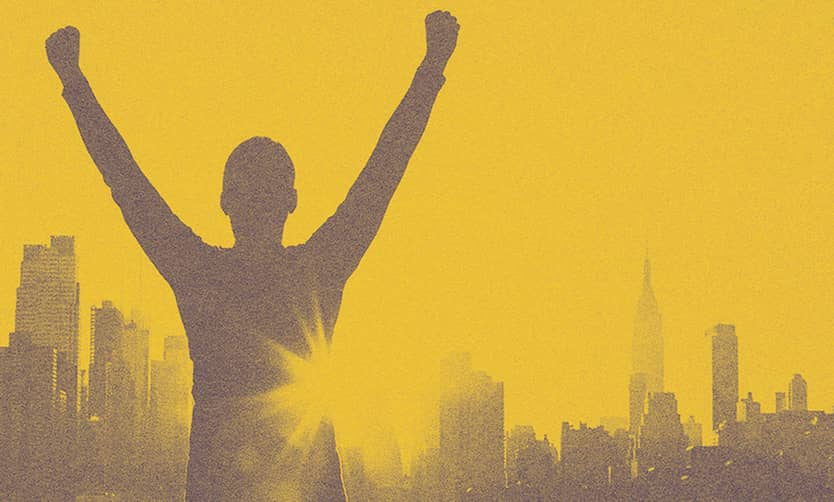 A person looking at the NYC with his arms up.