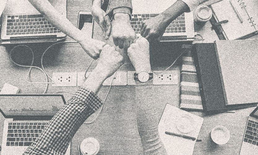 Several people fisting together.