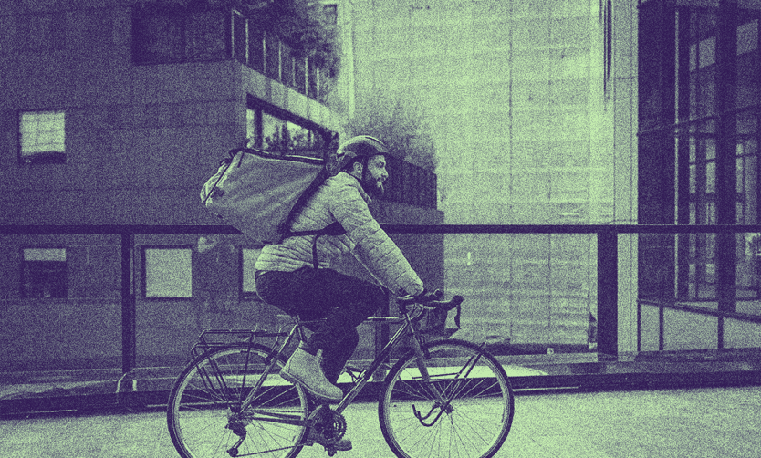 A person with a PERM Green Card riding a bike outside.