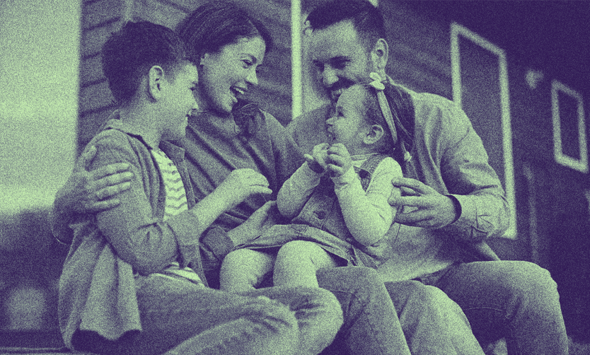 A family with two kids is outside together.