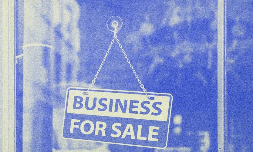 Front of a store with a sign on the glass door.