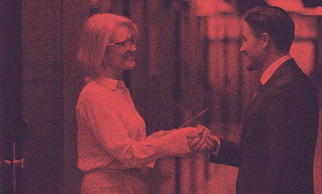 A woman and man shaking hands.