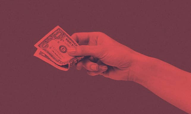 A person holding a dollar bill.