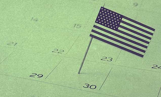 A mini U.S. flag planted on a calendar.