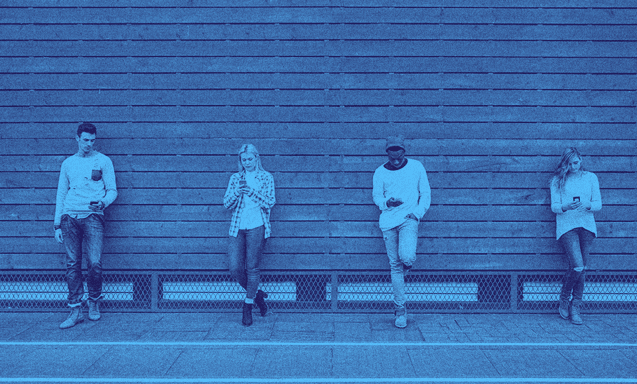 Four people leaning against a wall side by side.