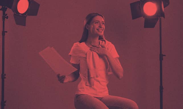 A person in a film set reciting a text.