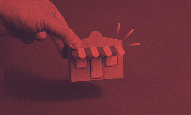 A person holds a model of a home.