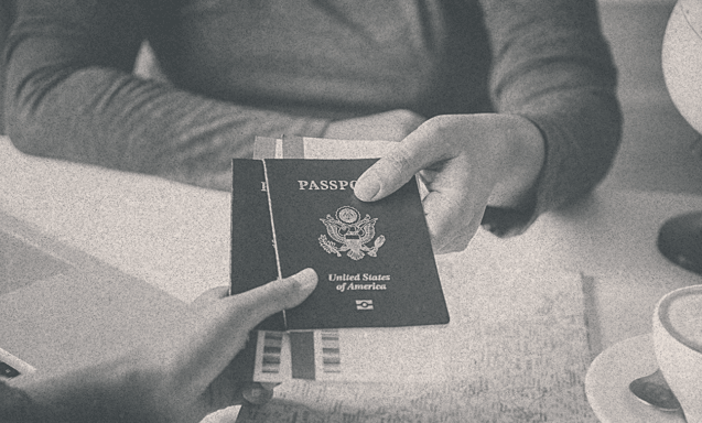 A person receiving his passport from some other person.