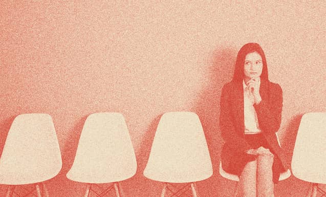 A woman sitting on a chair, thinking.