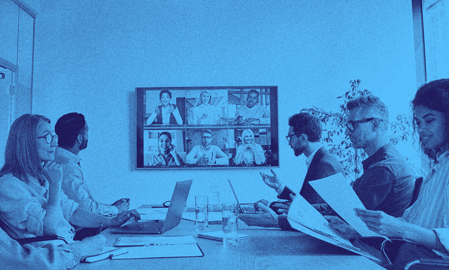 A group of people with the UK scale-up visa working in an office space.