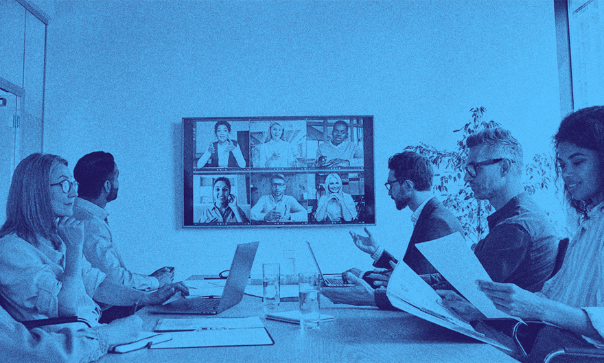 A group of people with the UK scale-up visa working in an office space.