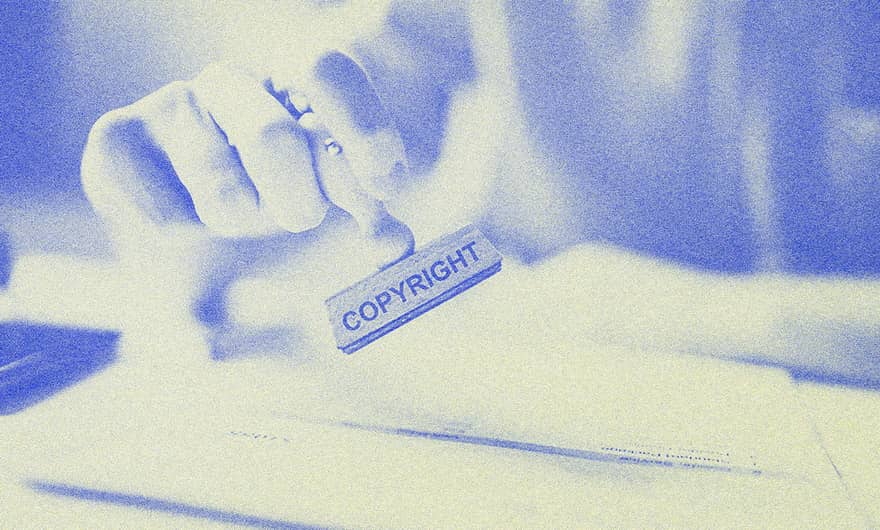 A person holding a stamp.