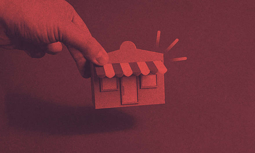A person holds a model of a home.
