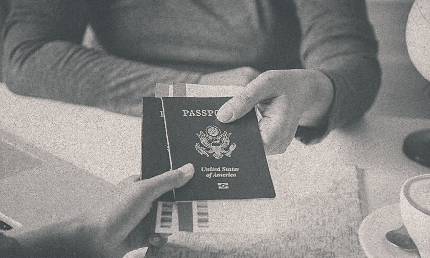 A person receiving his passport from some other person.