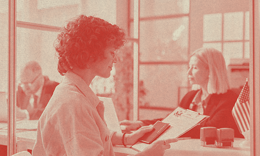 A person looks at a form smiling in an office space.